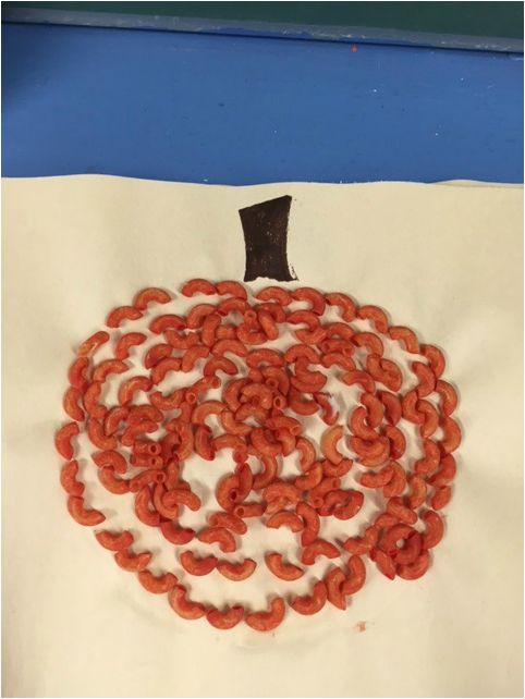 Look what we made with the orange macaroni! - SJA Kindergarten Monkeys!